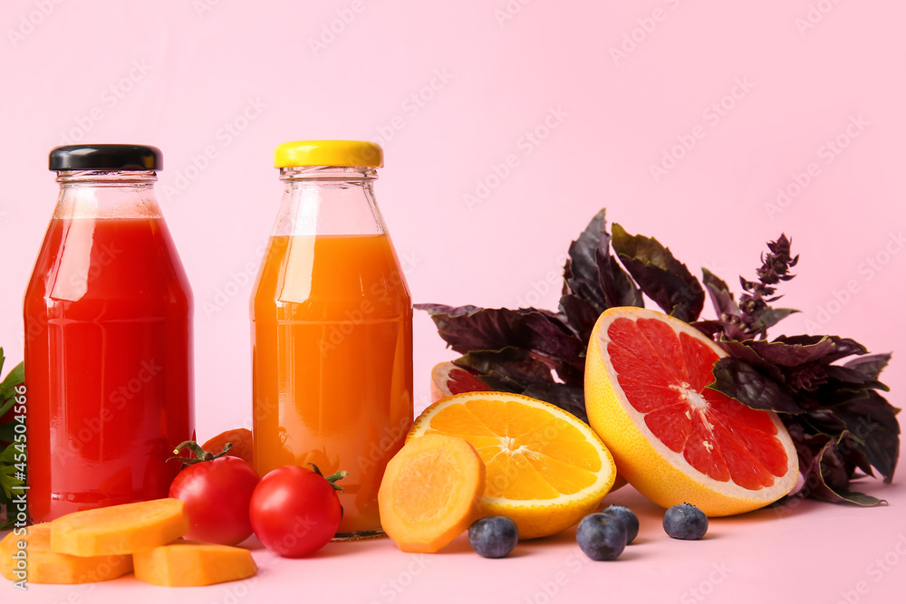 Bottles with healthy juice, fruits and vegetables on color background