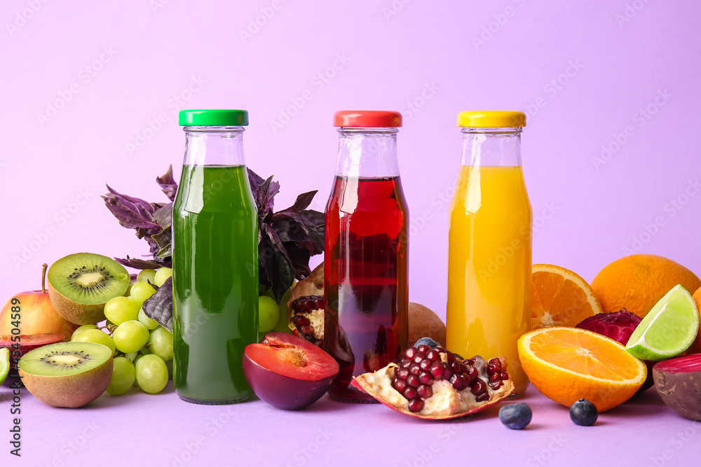 Bottles with healthy juice and fruits on color background