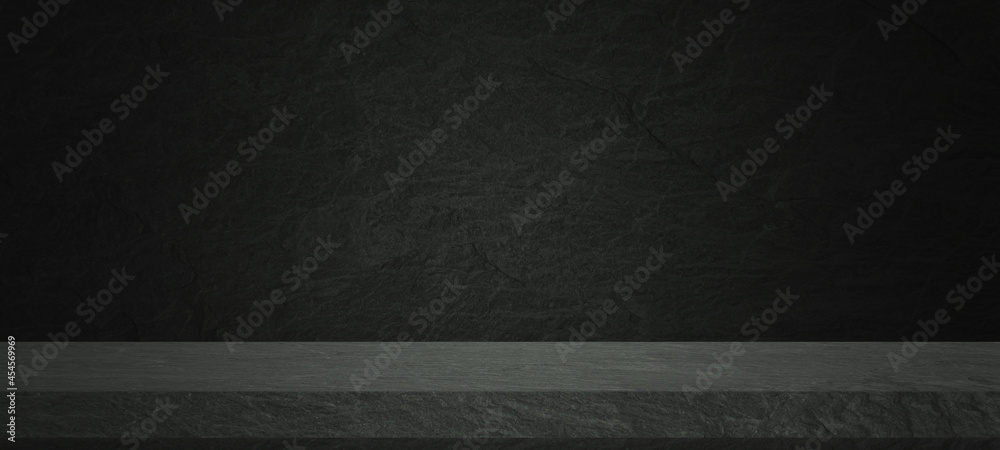 Empty dark stone tabletop or concrete shelf table on black wall background for montage product displ