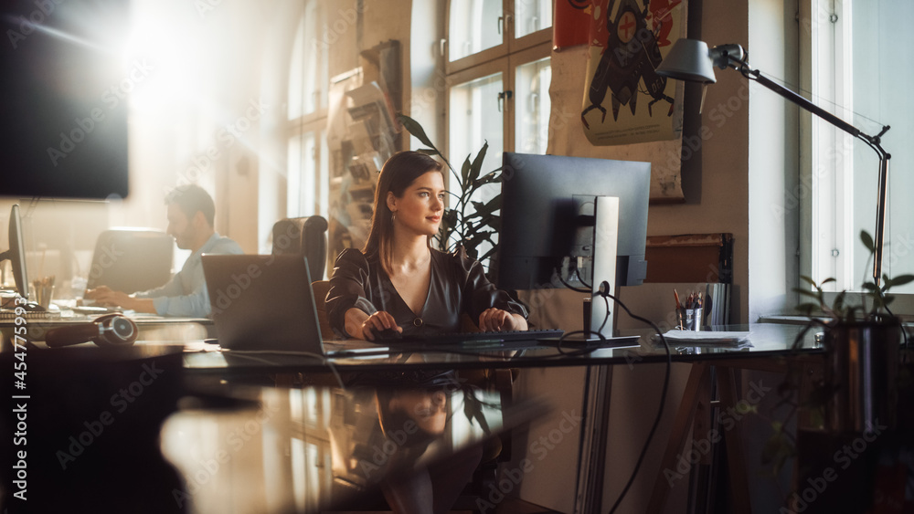 Two Stylish Employees Working on Computers in Creative Agency in Loft Office. Beautiful Manager Typi