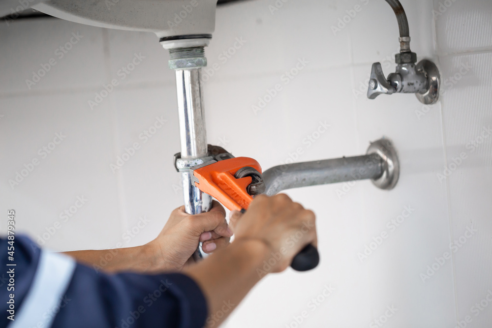 plumber at work in a bathroom, plumbing repair service, assemble and install concept.