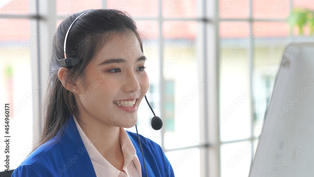 Businesswoman wearing headset working actively in office . Call center, telemarketing, customer supp