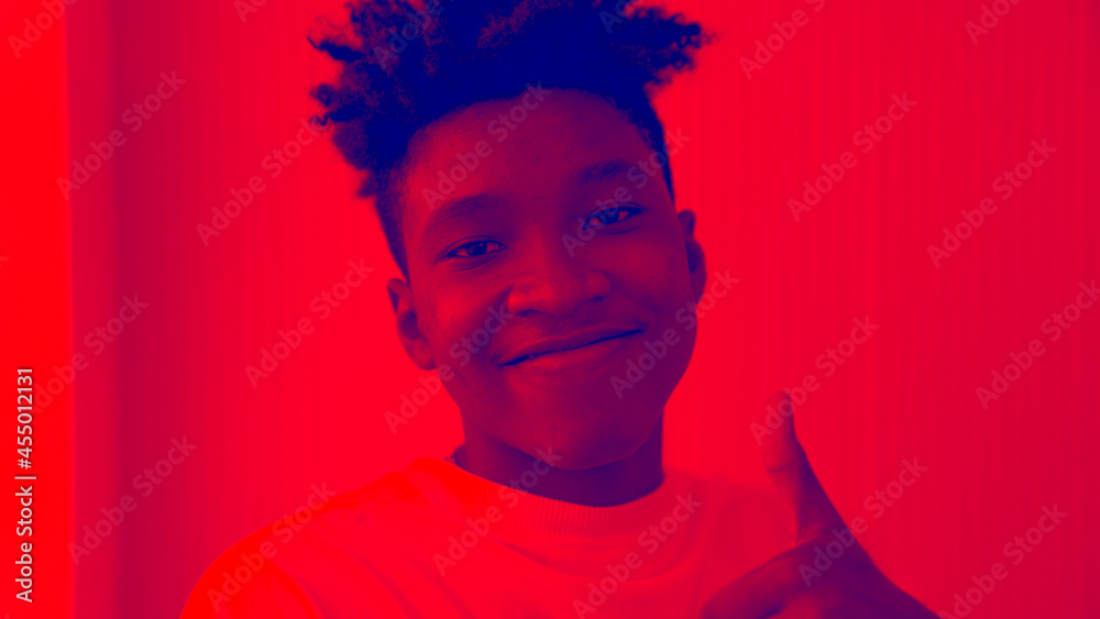 Duotone or half tone portrait of young african american man in studio looking at camera