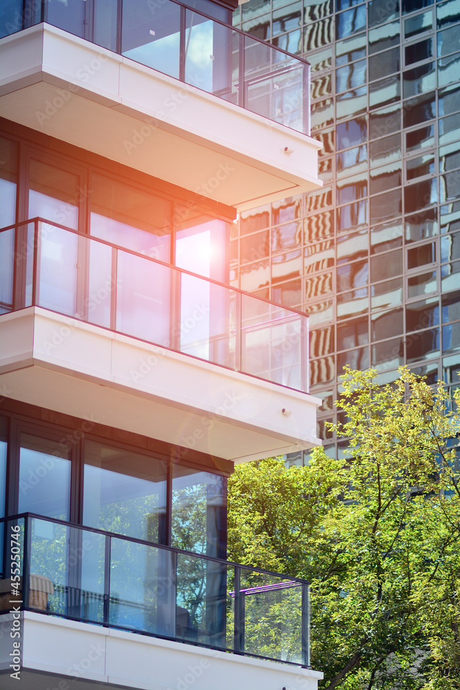 Eco architecture. Green tree and new apartment building. The harmony of nature and modernity.