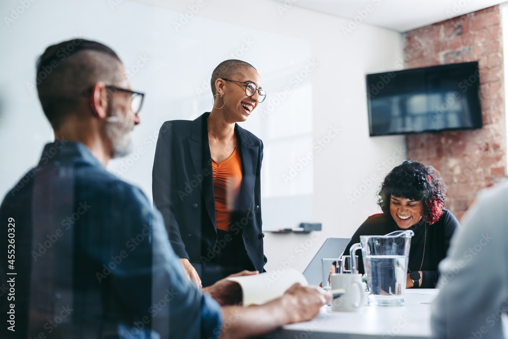 Businesspeople laughing during a briefing