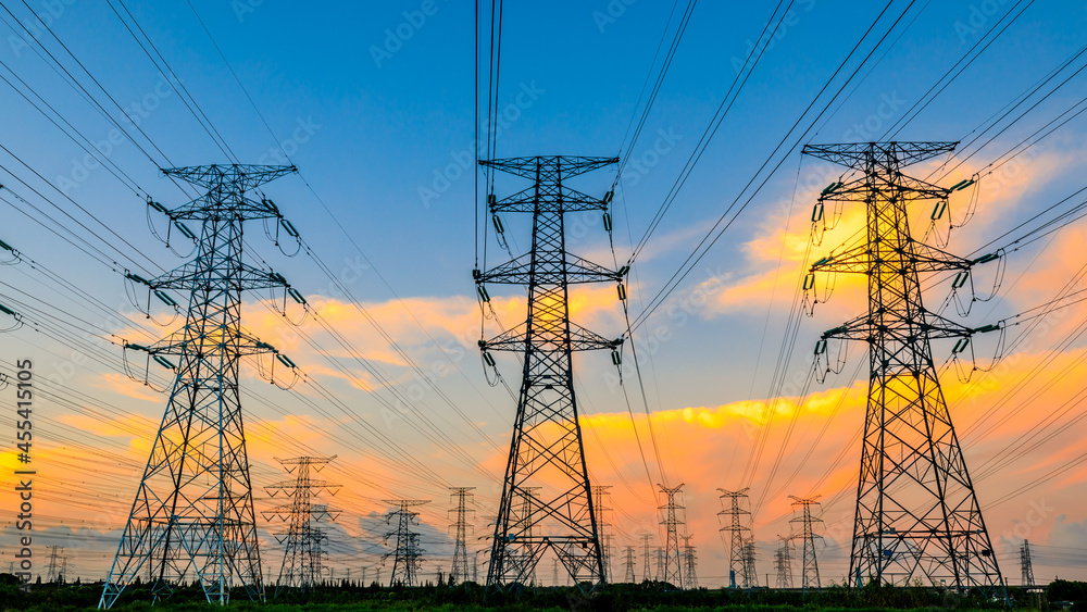 High voltage power tower industrial landscape at sunrise,urban power transmission lines.