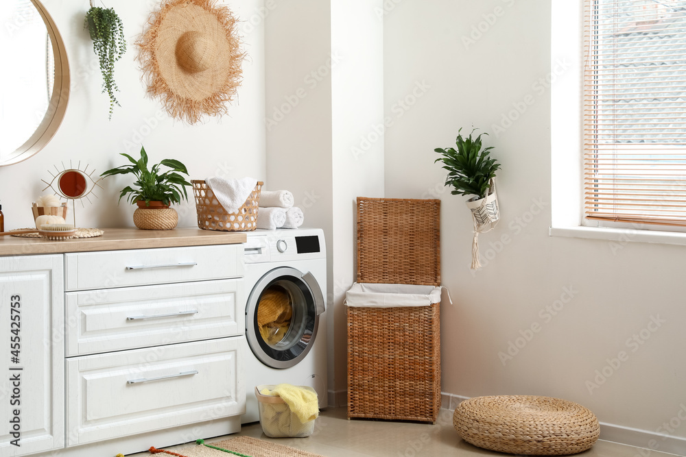 Interior of bathroom with modern washing machine