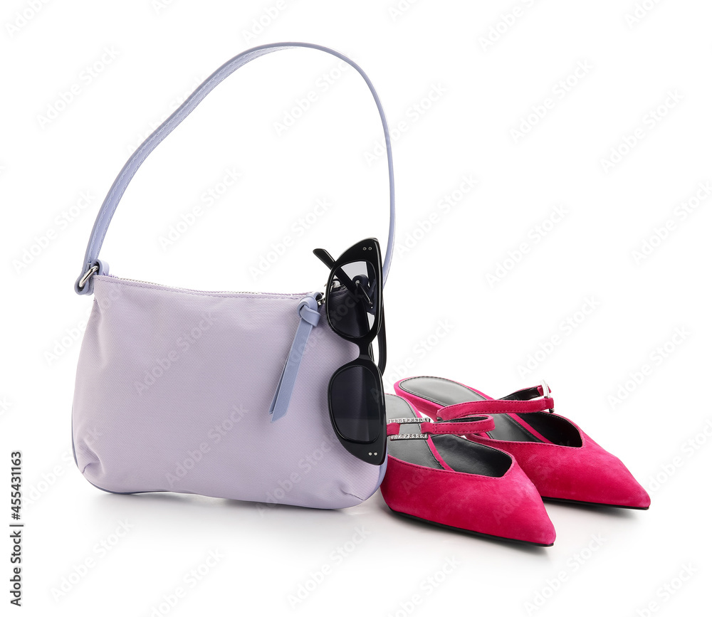 Stylish handbag, shoes and glasses on white background