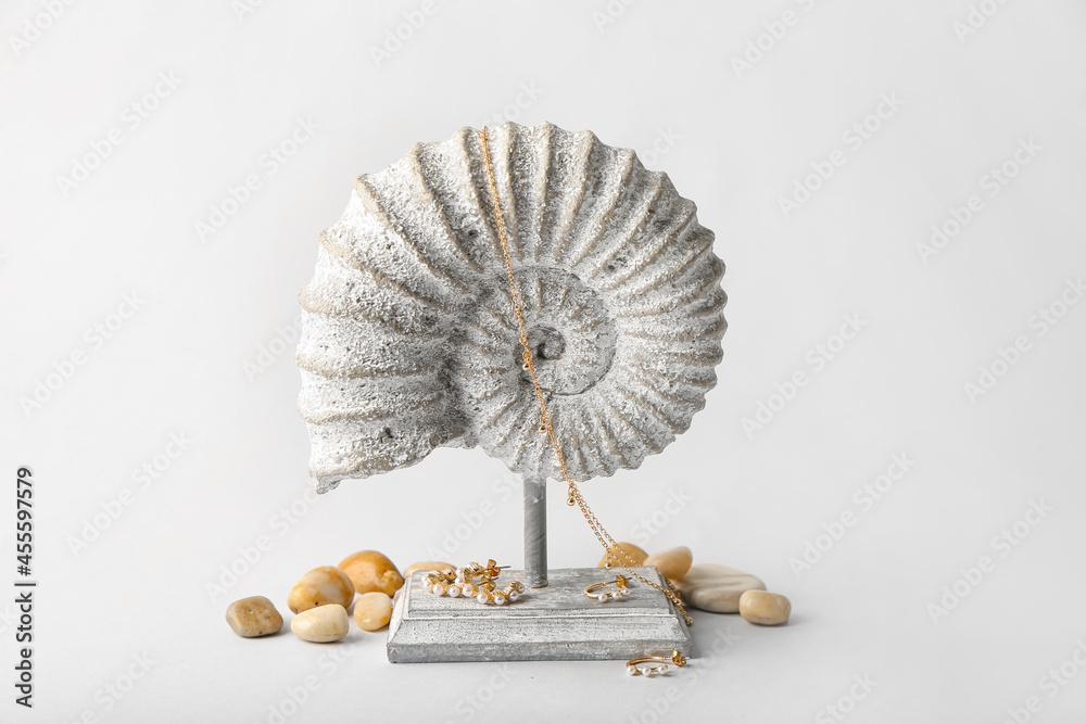 Stylish accessories and decor on light background