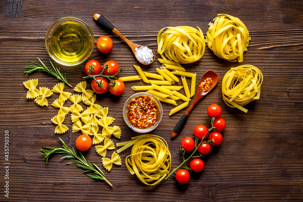 Pasta ingredients with tomatoes olive oil spices and herbs