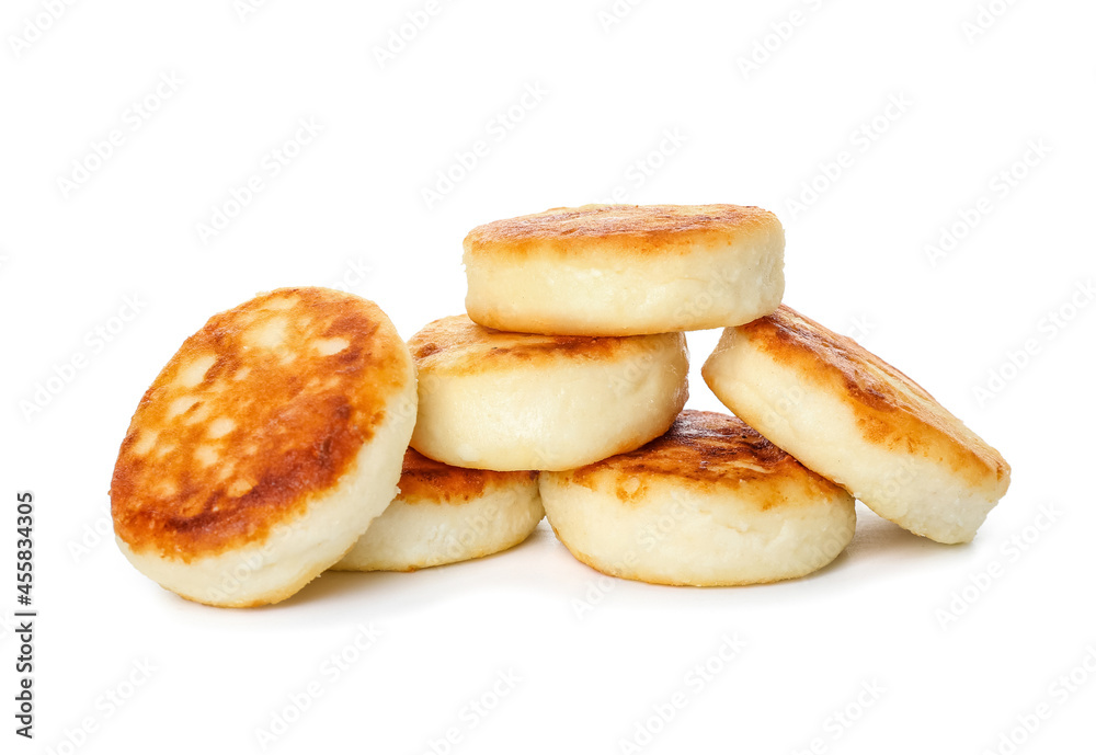 Tasty cottage cheese pancakes on white background