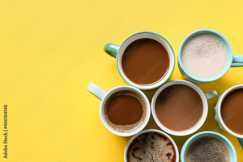 Cups of tasty coffee on color background