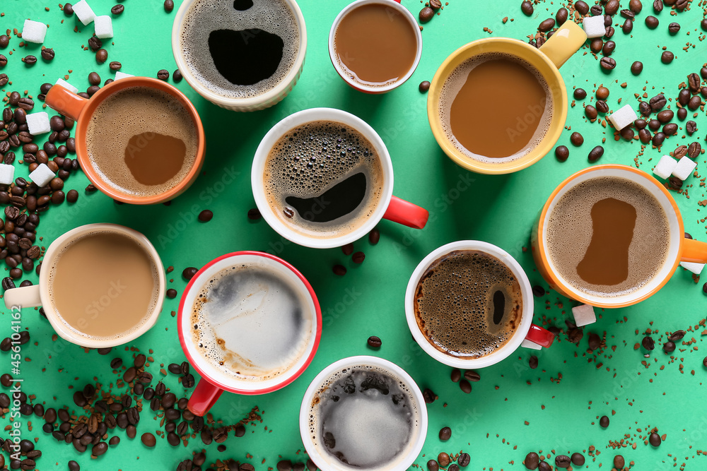 Cups of tasty coffee, beans and sugar on color background