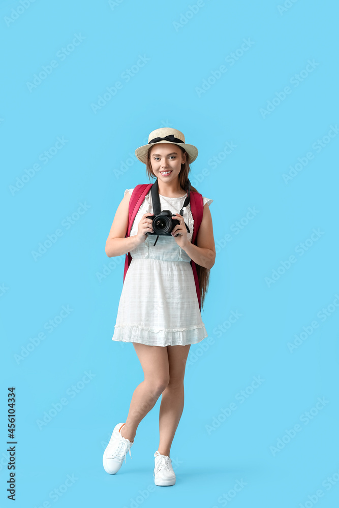 Female tourist on color background