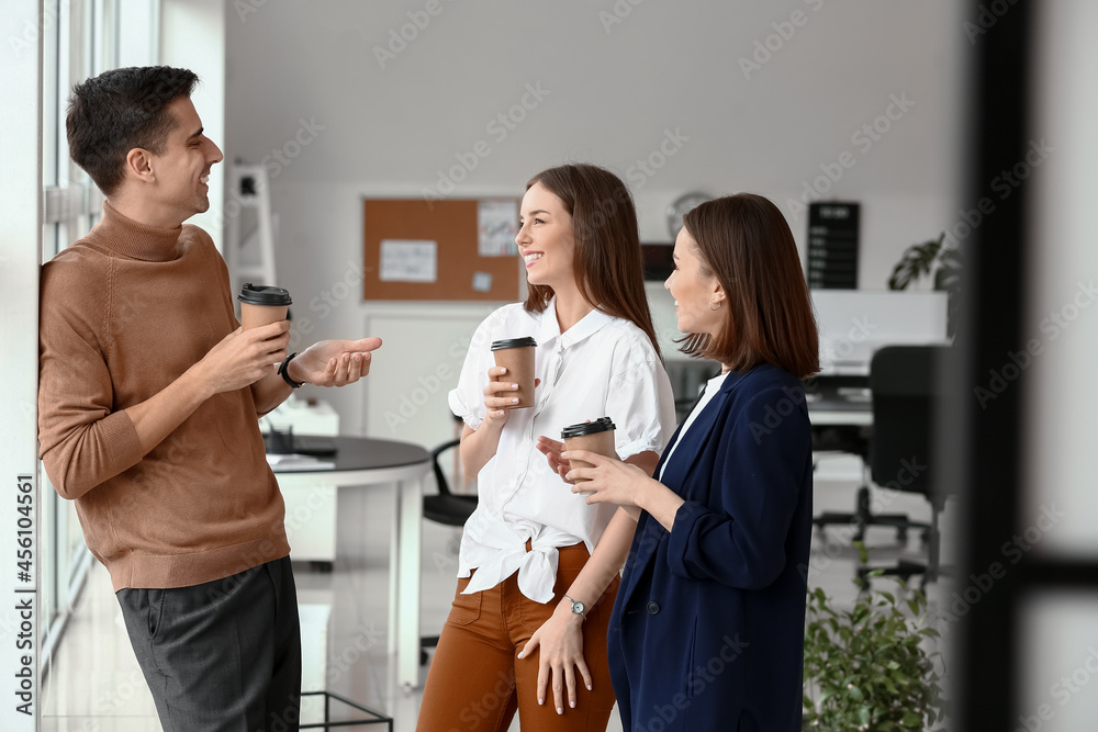 Business colleagues drinking coffee in office