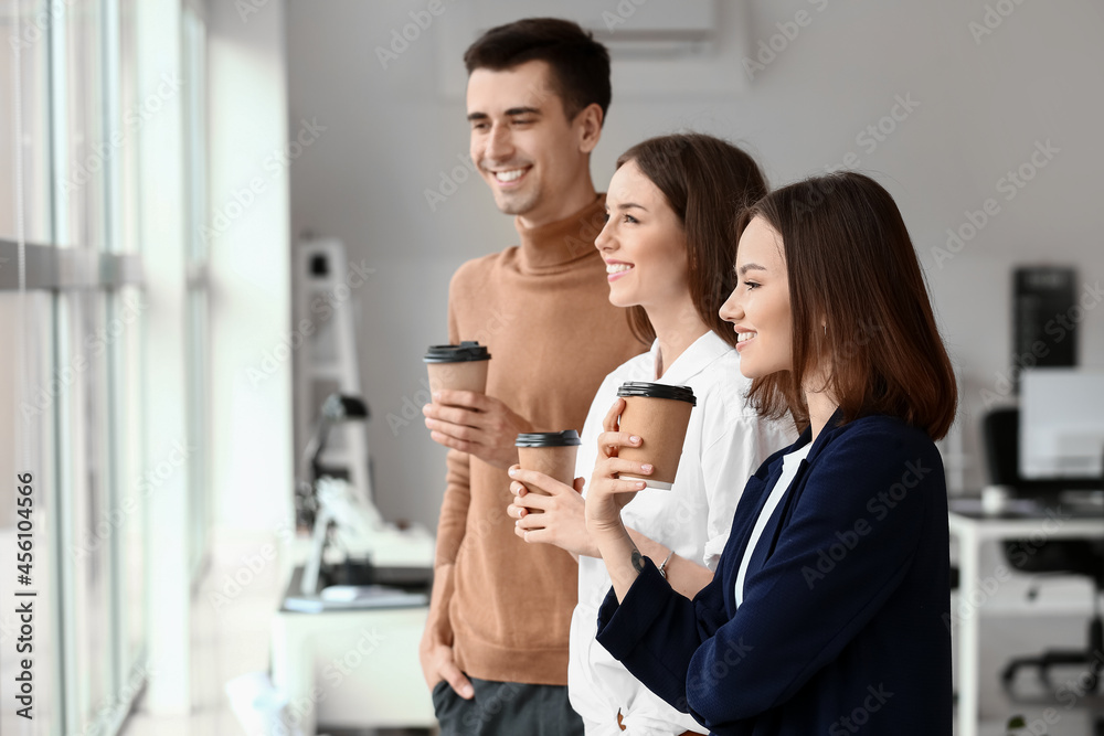 Business colleagues drinking coffee in office