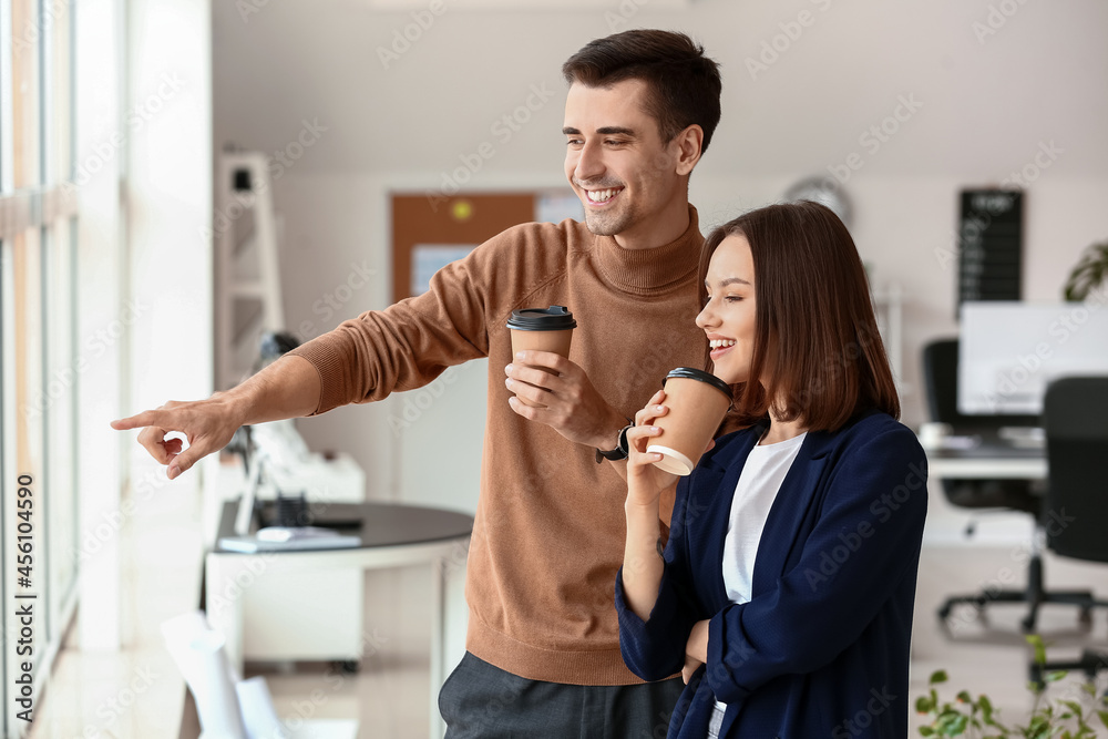 Business colleagues drinking coffee in office