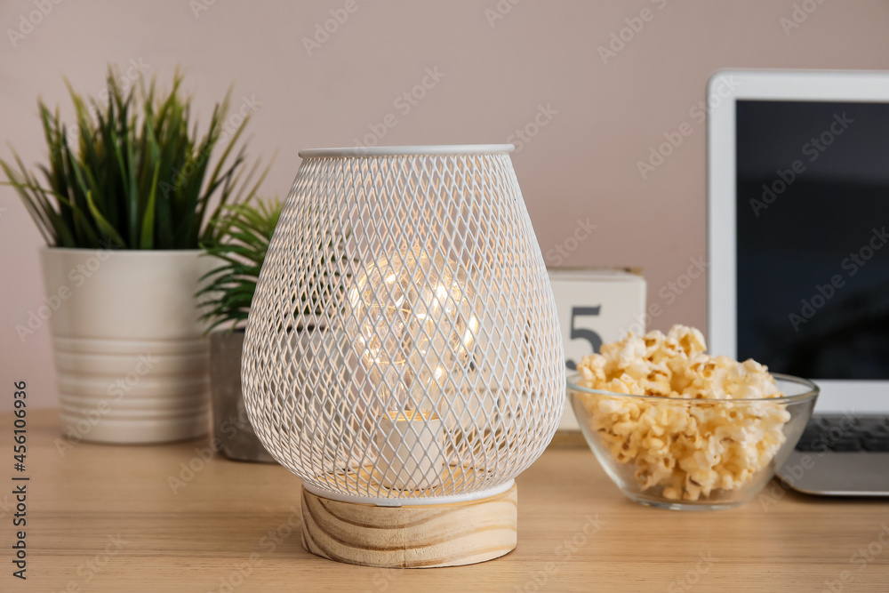 Stylish lamp on table in room