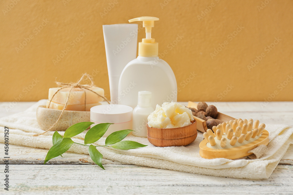 Bowl of shea butter and bath supplies on table