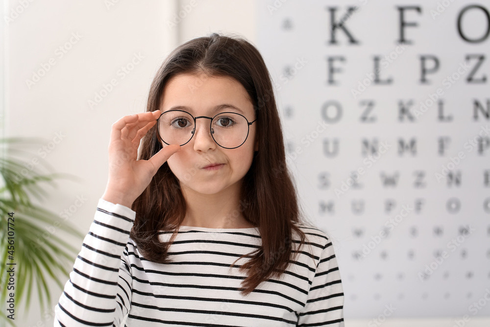 Little girl wearing new eyeglasses at ophthalmologists office