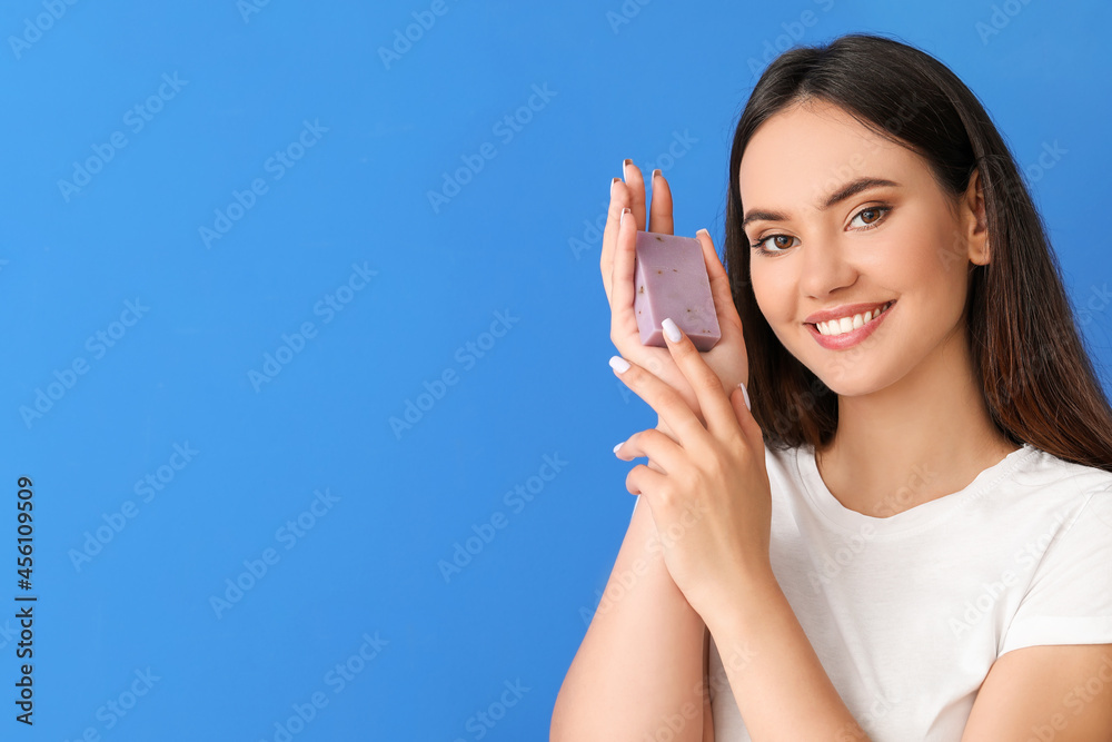 Beautiful young woman with soap on color background