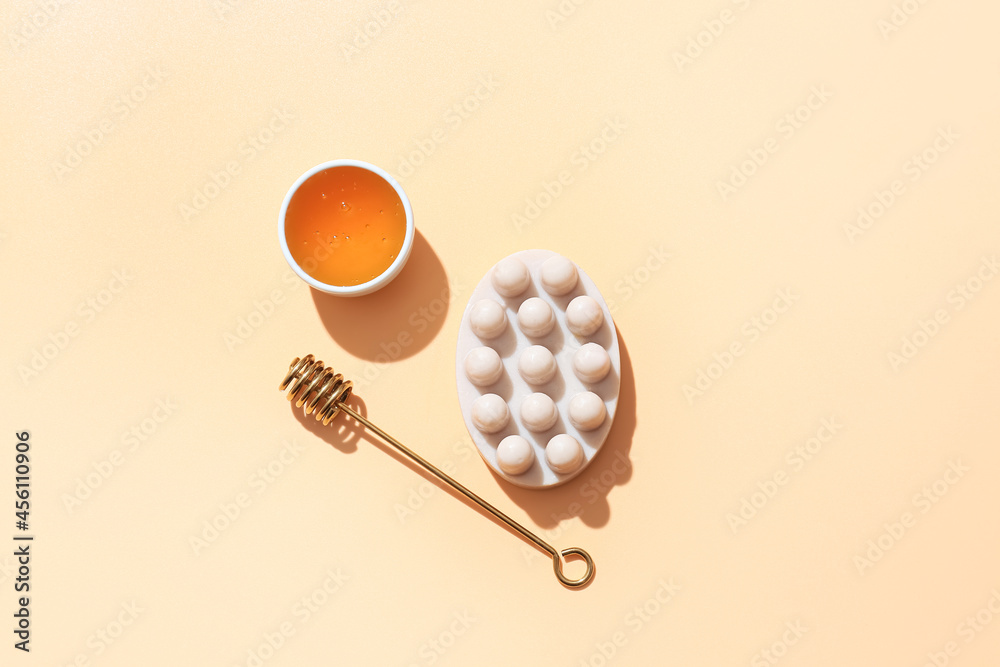 Massage soap bar, honey and dipper on color background