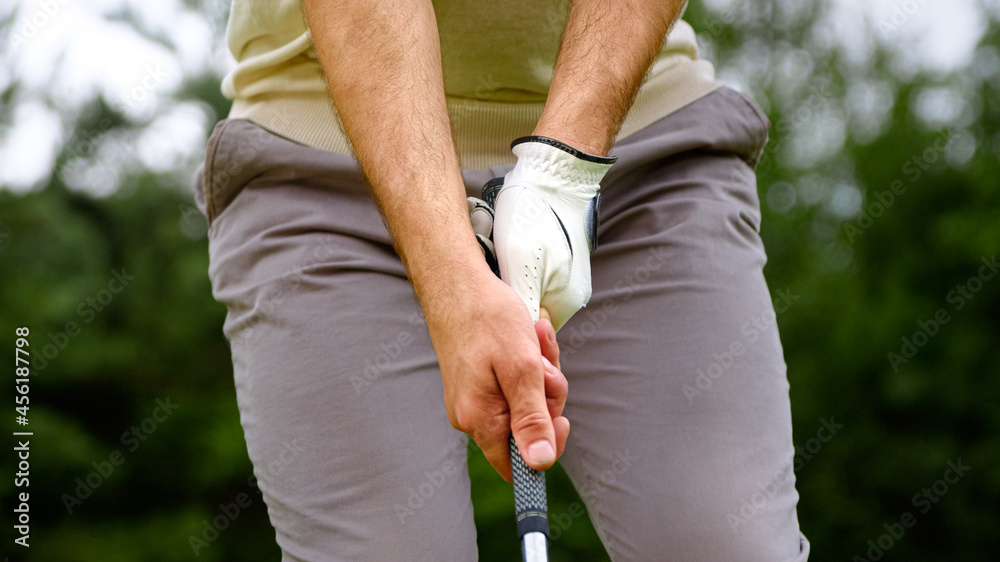 Young golfer hitting golf ball on a course