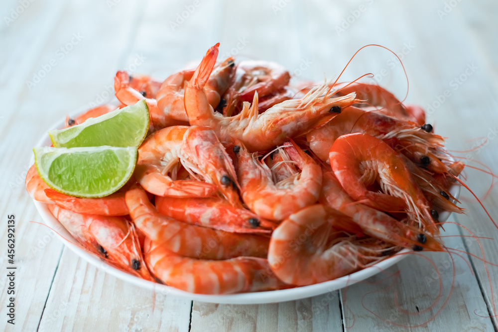 Big boiled shrimps in white plate close up. Seafood concept. Food photography