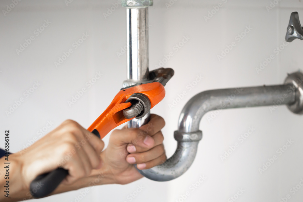 plumber at work in a bathroom, plumbing repair service, assemble and install concept.