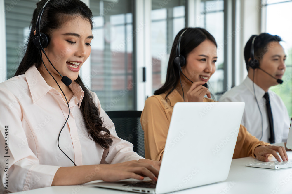 Business people wearing headset working actively in office . Call center, telemarketing, customer su