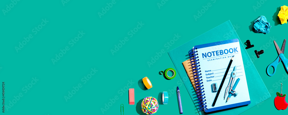 Notebooks with school supplies overhead view - flat lay