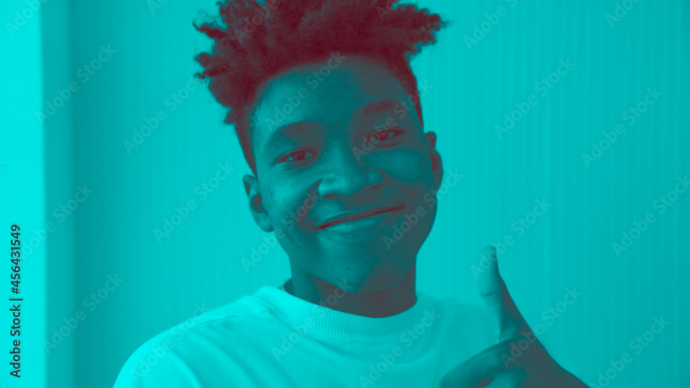 Duotone or half tone portrait of young african american man in studio looking at camera