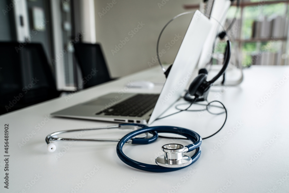 Headset and doctor equipment at clinic ready for actively support for patient by online video call .