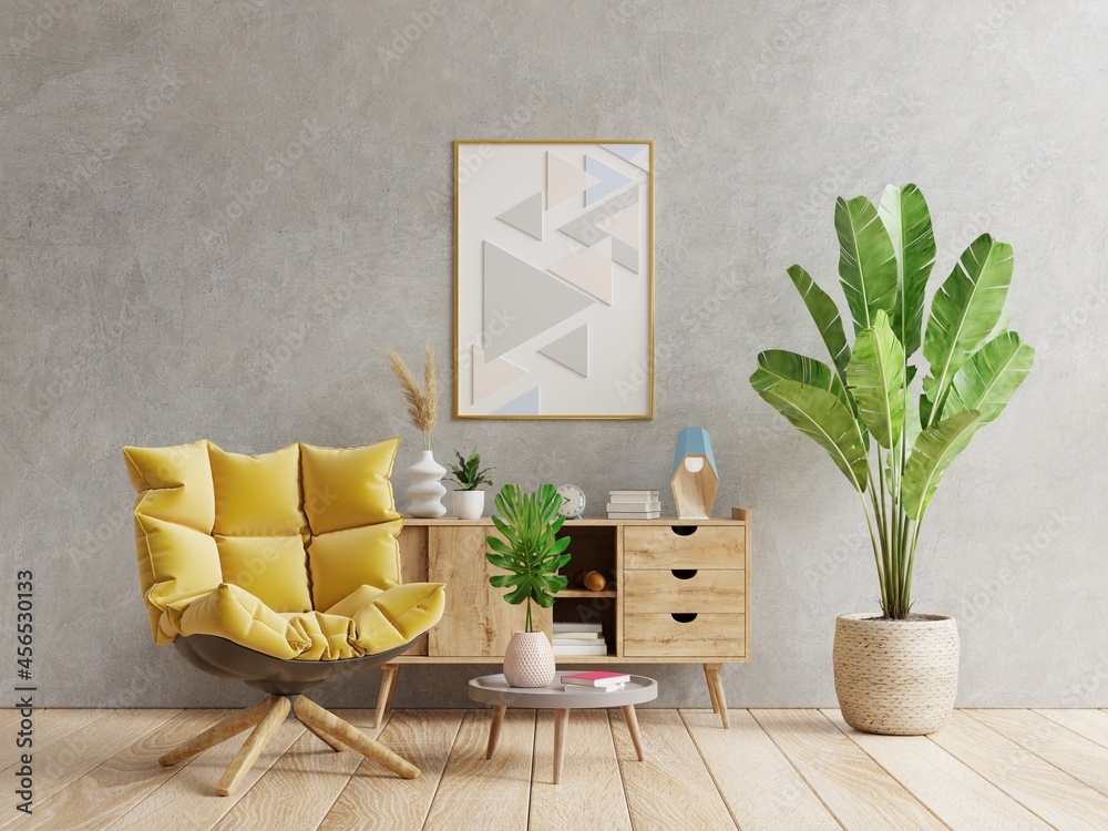 Poster mockup with vertical frame on empty dark concrete wall in living room interior with yellow ar