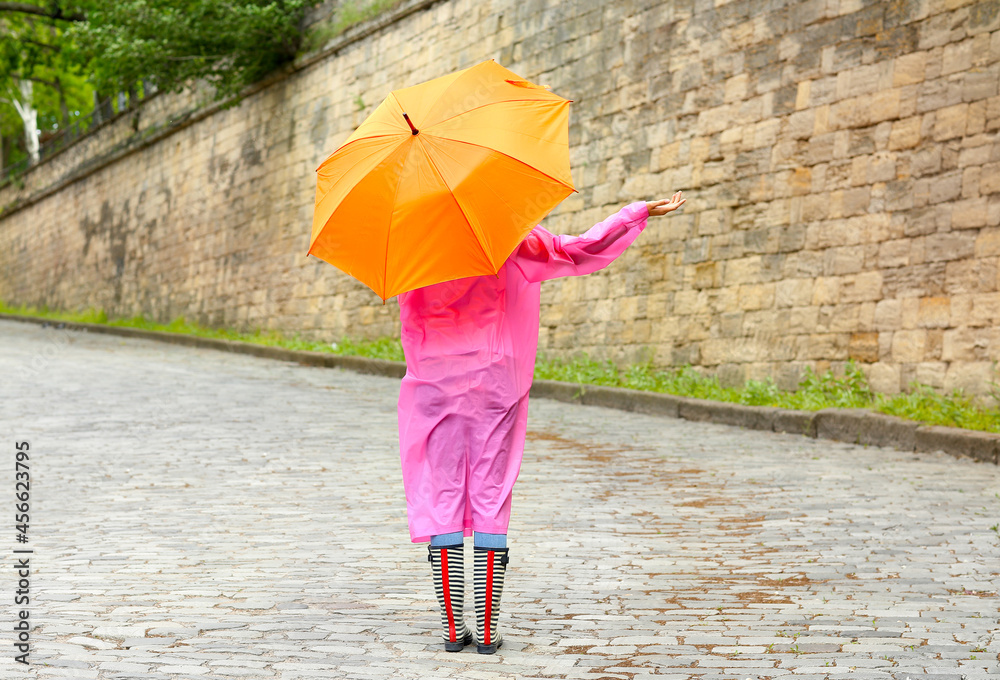 Beautiful young woman with umbrella outdoors