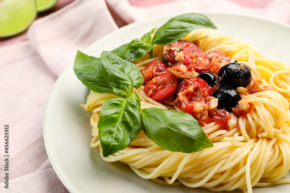 Plate with tasty Pasta Puttanesca on table, closeup