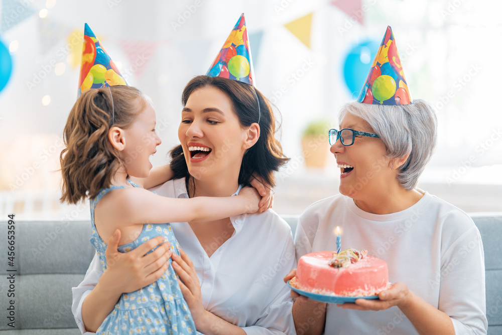 Grandmother, mother and daughter are celebrating birthday.