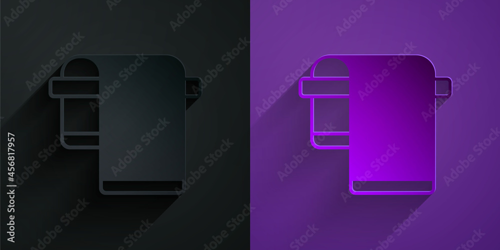 Paper cut Towel on hanger icon isolated on black on purple background. Bathroom towel icon. Paper ar