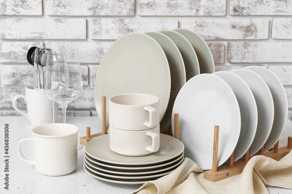 Set of clean dishes on table in kitchen