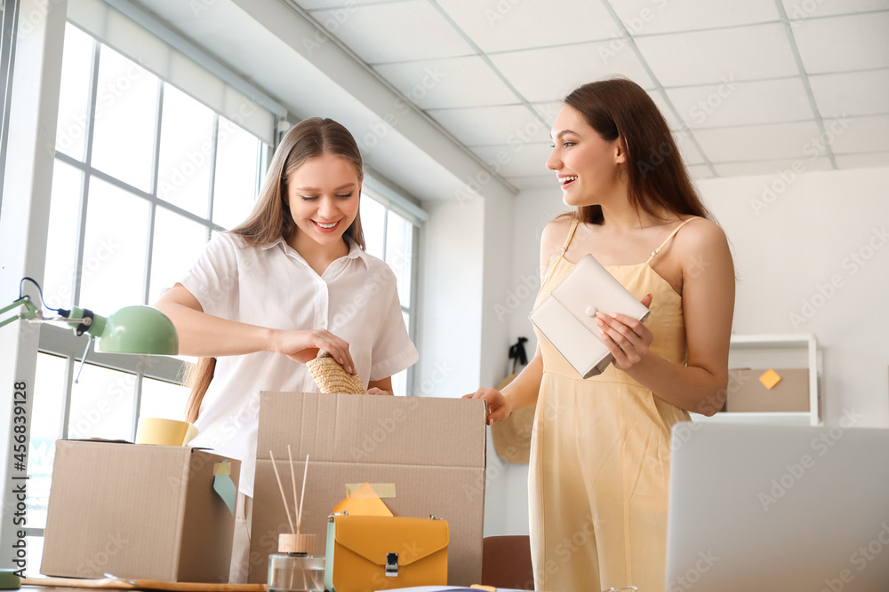 Female business owner and seller packing order in warehouse store