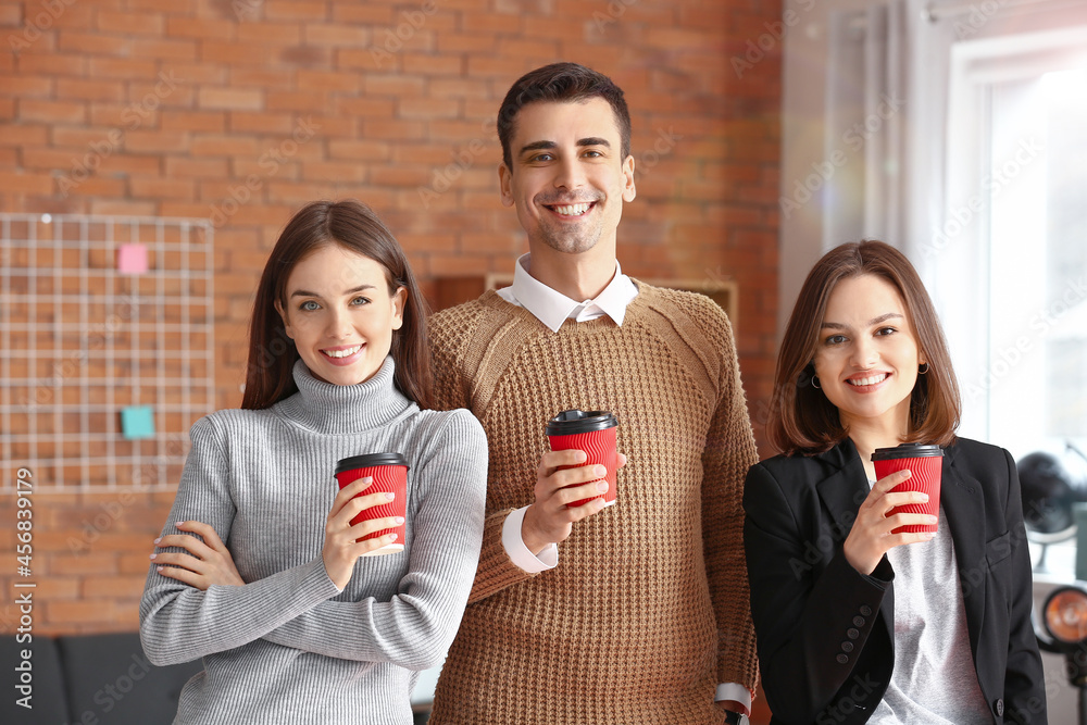 Business colleagues drinking coffee in office