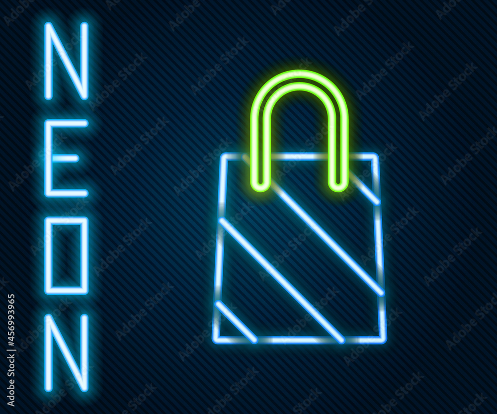 Glowing neon line Christmas paper shopping bag icon isolated on black background. Package sign. Merr