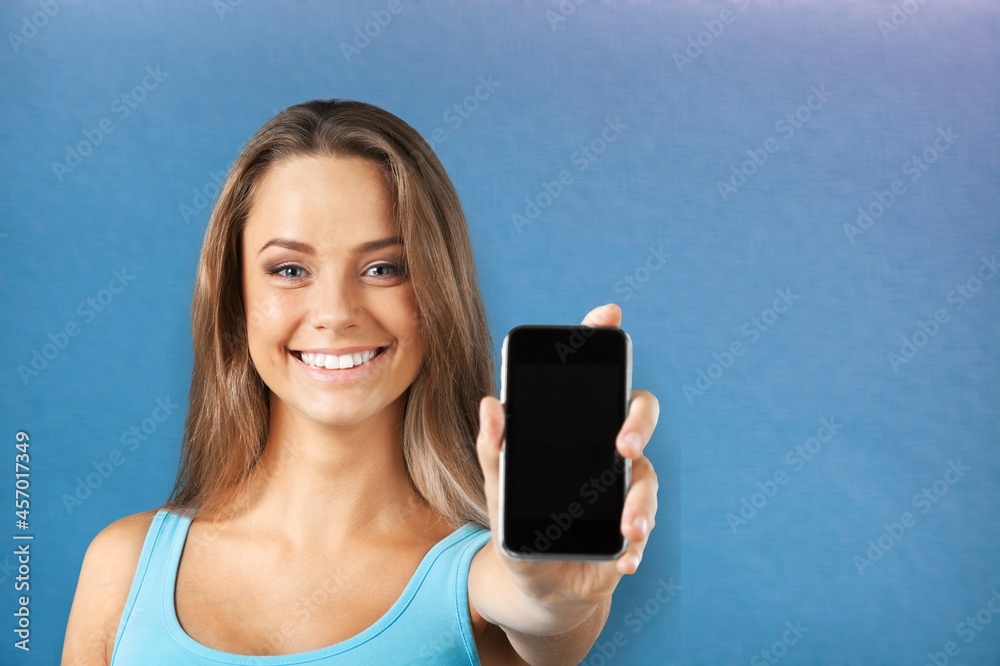 Young girl show empty smartphone with positive expression,