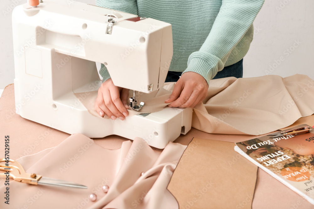 Woman sewing clothes at table