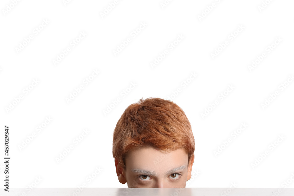 Teenage boy with dyed eyebrows on white background