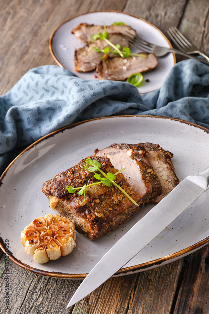 Plate with tasty beef brisket on table