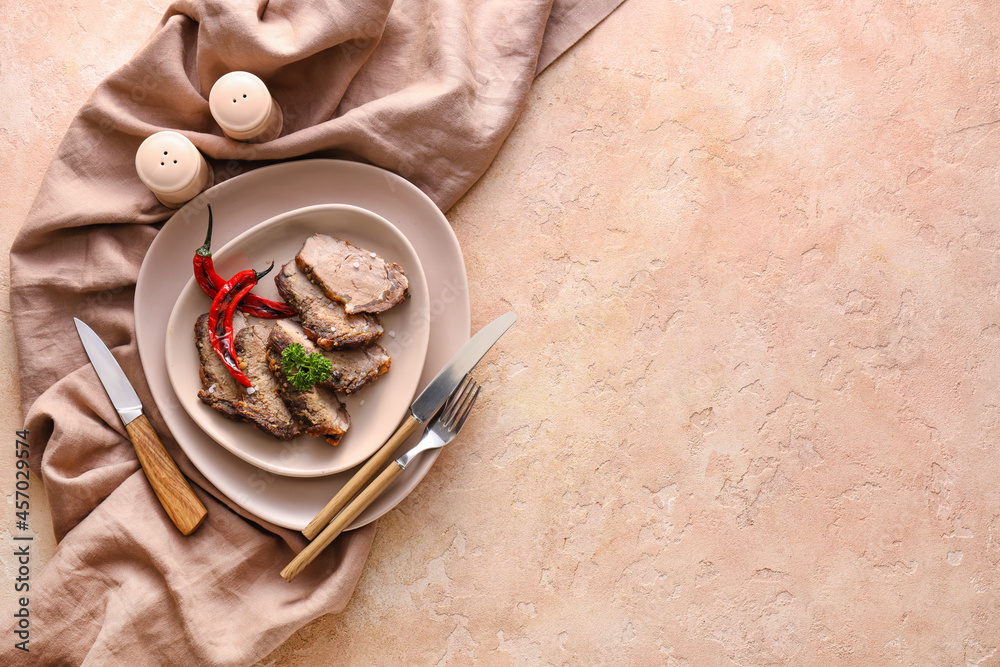 Plate with tasty beef brisket on color background