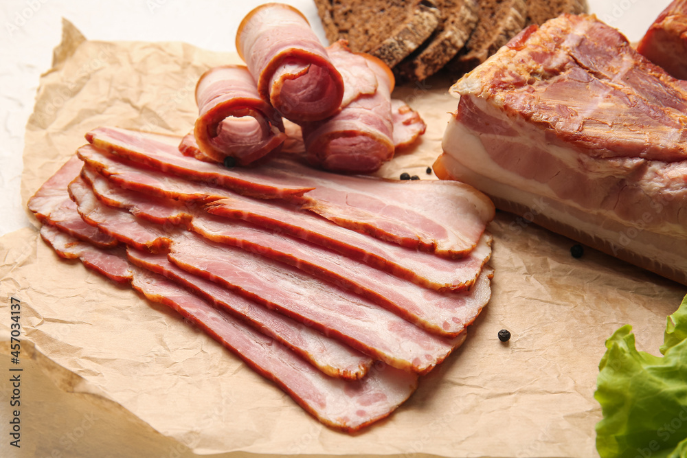 Tasty smoked bacon on light background