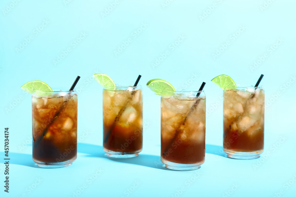 Glasses of tasty Long Island iced tea on color background