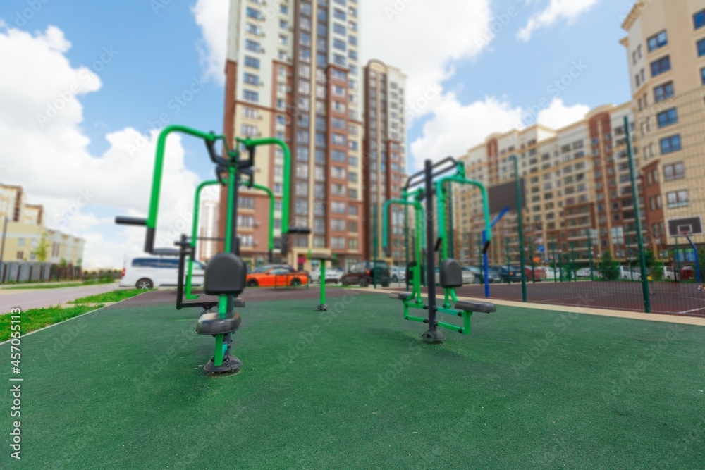 City courtyard or street with cars and playgrounds for children and walks.